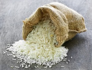 Raw long grain white rice grains in burlap bag